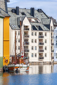 City view at the canal with a ship in alesund, norway