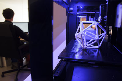 3d printers and man working with a computer