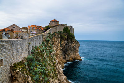 Built structures against the blue sea