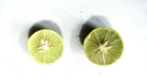 High angle view of lemon slice on white background