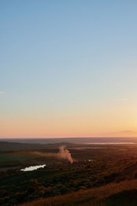 Scenic view of sea against clear sky during sunset
