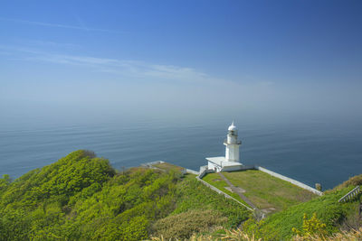 High angle view of lighthouse by sea against sky