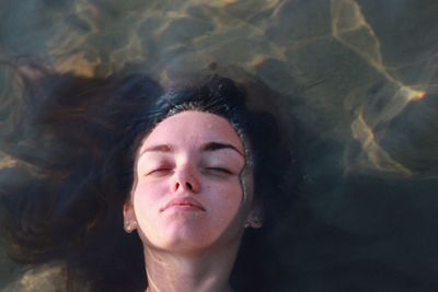 Portrait of a beautiful young woman with eyes closed