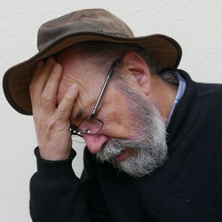 Close-up of tensed man against wall