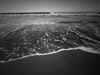 Scenic view of beach against clear sky