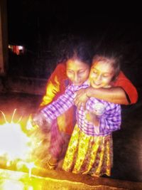 High angle view of mother and daughter at night