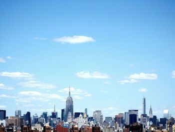 Modern cityscape against blue sky