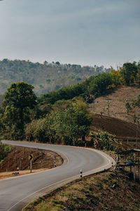 High angle view of road by trees against sky