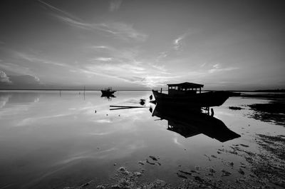 Fishing boats in sea against sky