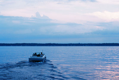 Boat sailing in sea against sky