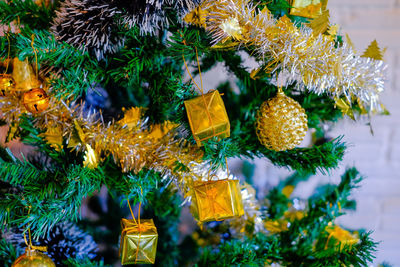 Close-up of christmas decorations hanging on tree