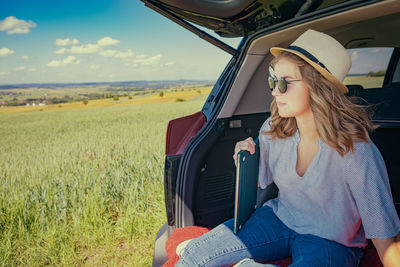 Young woman sitting on field