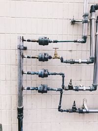 Row of pipes against wall