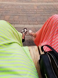 Low section of man with umbrella on wood