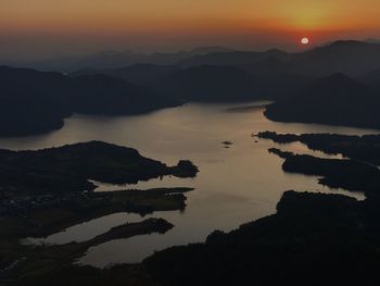 Scenic view of silhouette mountains against sky at sunset