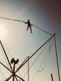 Low angle view of silhouette rope against clear sky