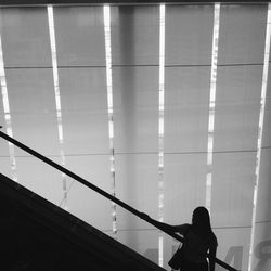 Rear view of silhouette woman standing against the sky