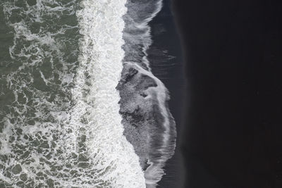 Close-up of sea waves splashing on beach