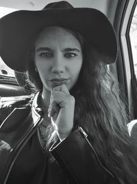 Portrait of woman wearing hat traveling in car