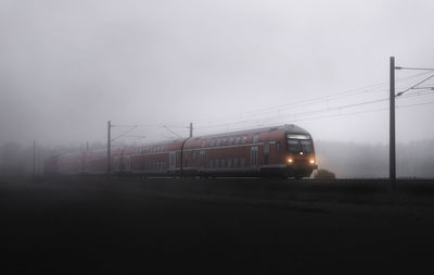 Train in foggy weather against sky