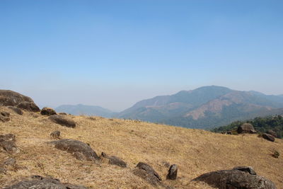 Scenic view of mountains against clear blue sky