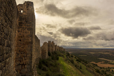 Old ruins of building against cloudy sky