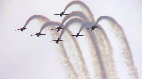 Low angle view of airplane flying against sky