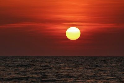 Idyllic view of seascape against orange sky