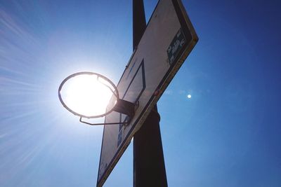 Low angle view of street light against blue sky