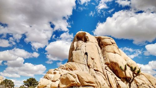 Low angle view of rock formations against blue sky at joshua tree national park