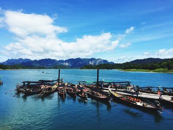 Boats moored on sea against sky