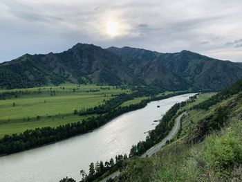 Scenic view of landscape and mountains against sky