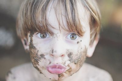 Close-up portrait of boy with dirty face