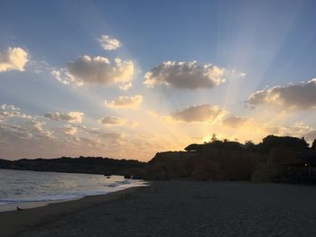Scenic view of beach against sky during sunset