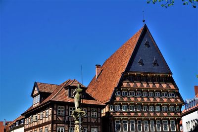 Low angle view of building against clear blue sky