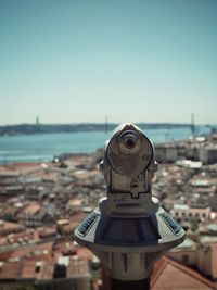 Close-up of coin-operated binoculars against sky