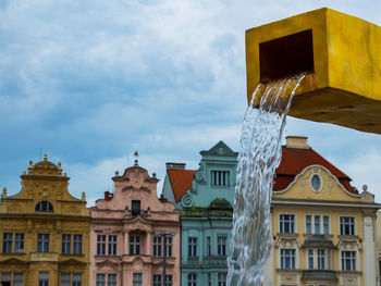 Low angle view of buildings in plzen against cloudy sky