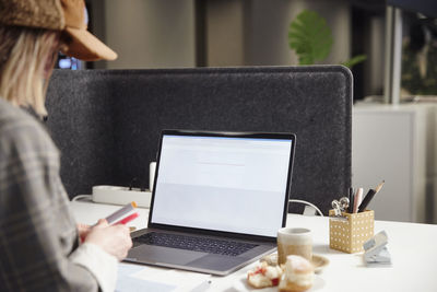 Woman using laptop in office