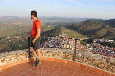 Man standing at observation point against sky