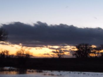 Scenic view of landscape against sky at sunset