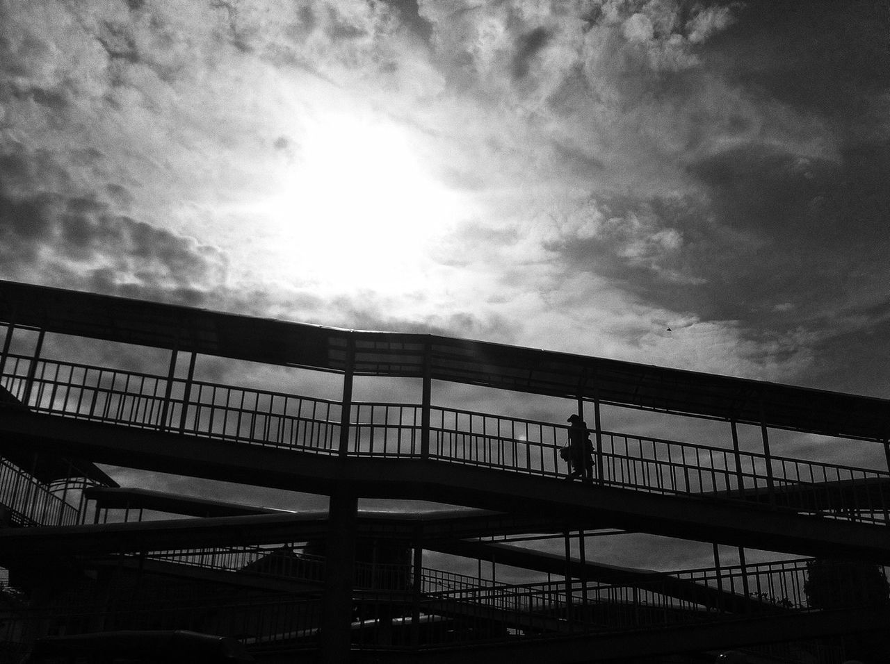 sky, low angle view, built structure, cloud - sky, architecture, cloudy, building exterior, cloud, railing, overcast, sunlight, no people, weather, outdoors, day, building, nature, silhouette, high section, roof