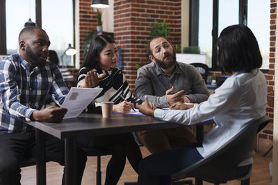 Business people conducting interview in office