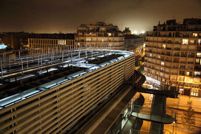 High angle view of illuminated buildings against sky at night