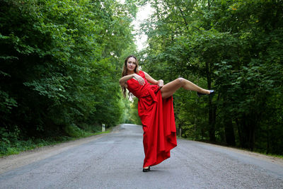 Rear view of woman standing against trees