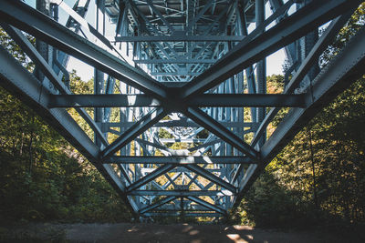 Low angle view of bridge amidst tree