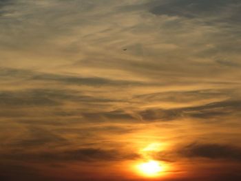 Low angle view of cloudy sky at sunset