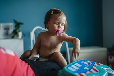 Portrait of boy playing with toy at home