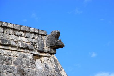 Low angle view of statue against blue sky