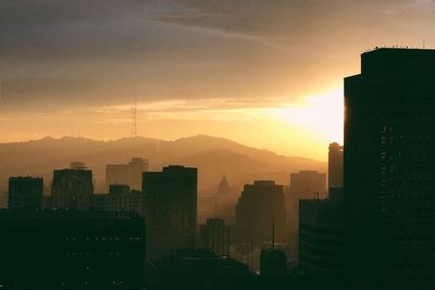 View of cityscape against dramatic sky