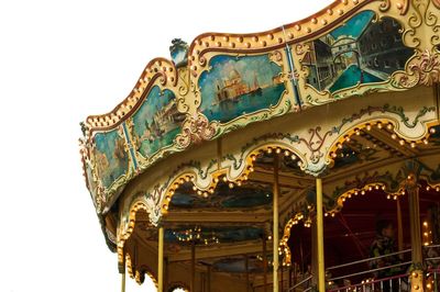 Low angle view of carousel against clear sky